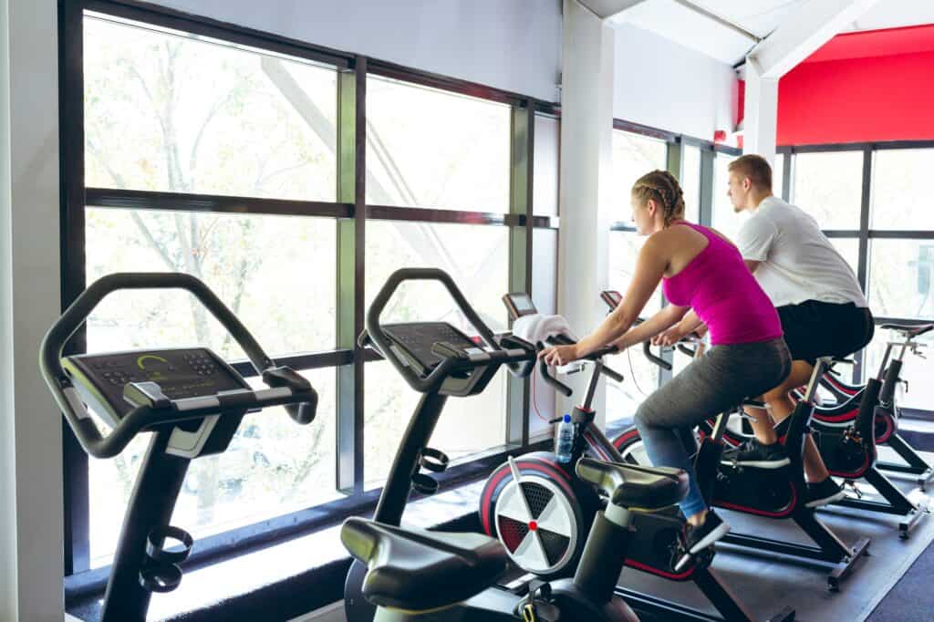 People at the gym exercising on stationary bikes