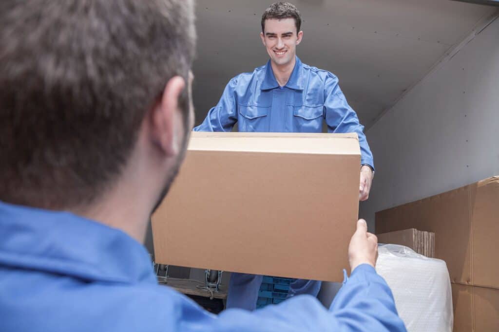 The movers unloading the moving van