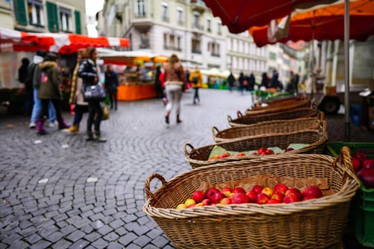 Apples in wicker baskets in a street market in the concept of 'best local shops and markets in Battersea for new residents'.