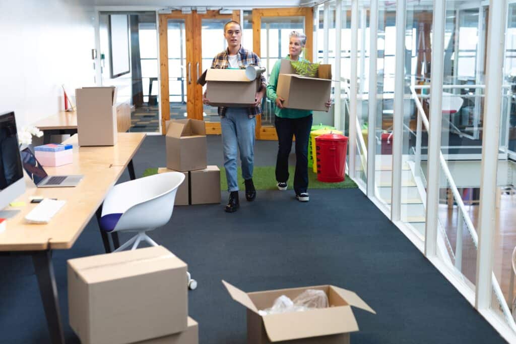 Employees arrived at their office carrying boxes containing their office stuff