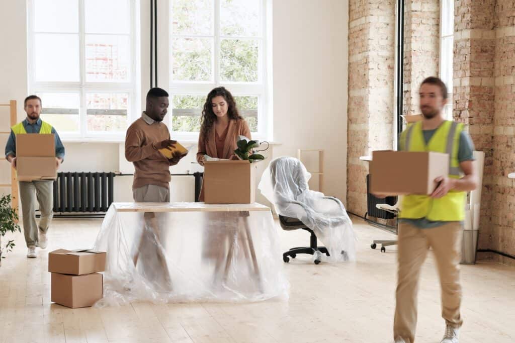 Office movers and moving committee in the old office in the concept of 'Benefits of Hiring a Professional Office Removal Service'.